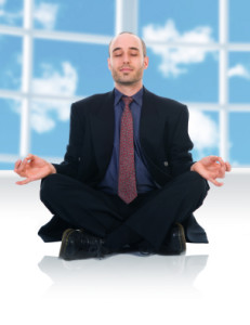business man in a meditation position on white
