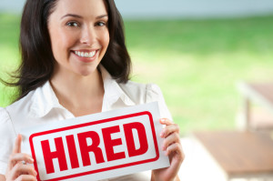 Attractive woman holding hired sign