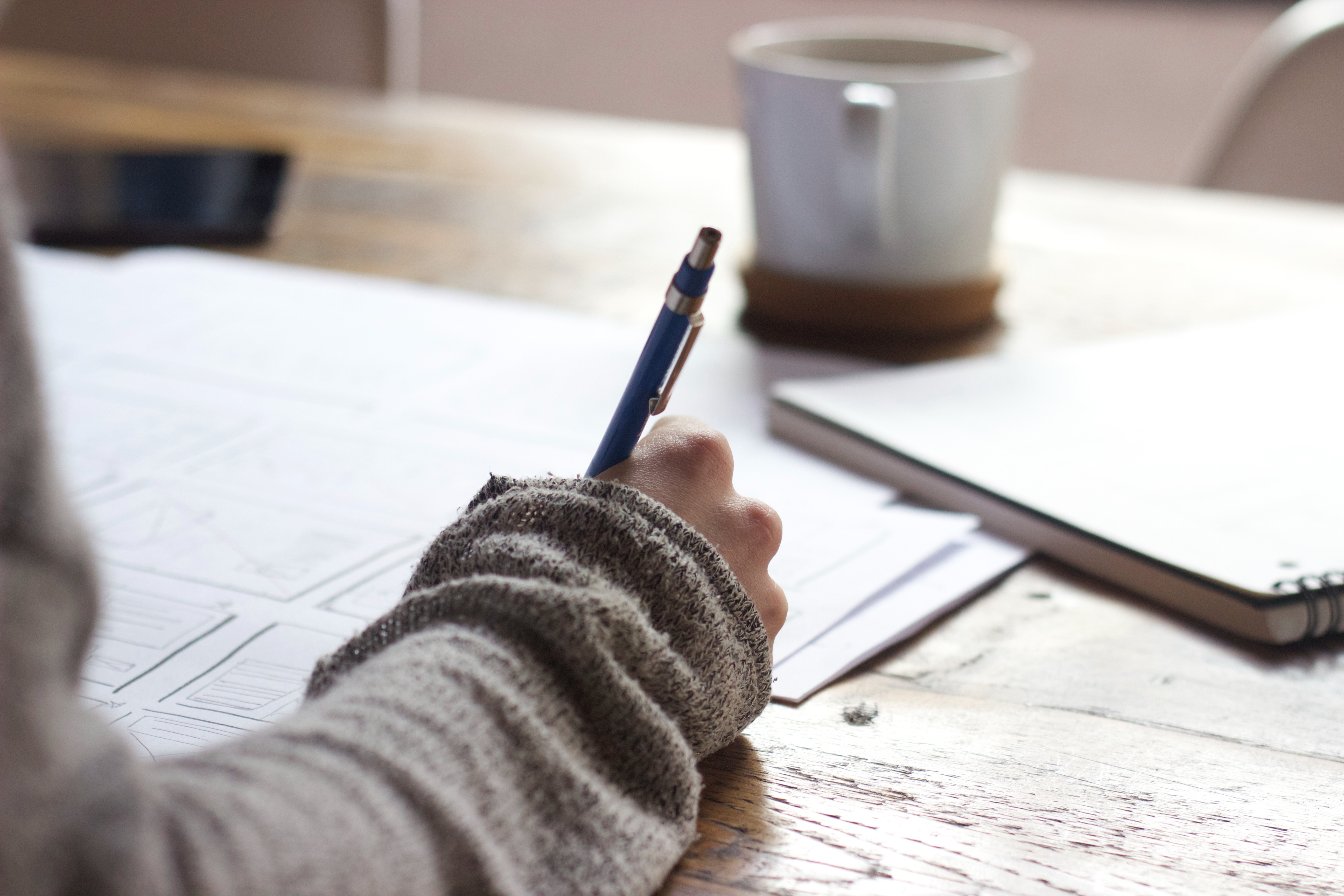 Person Writing and Studying for Test